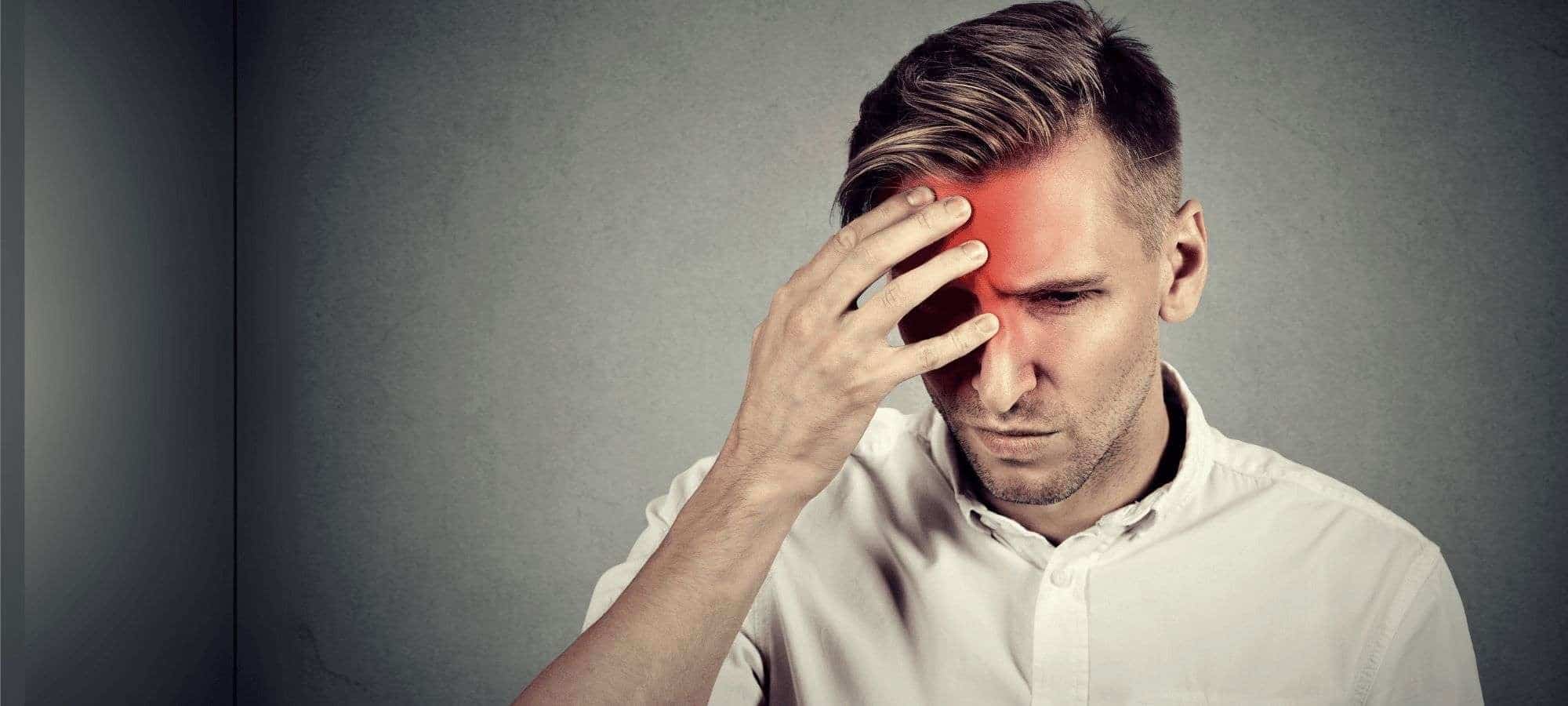 man holding head with a headache man-holding-head-with-a-headache